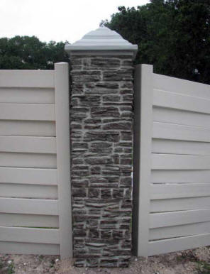 Faux rock pillar with vinyl fencing