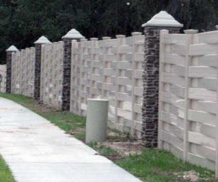 Vinyl fence with brown rock pillars