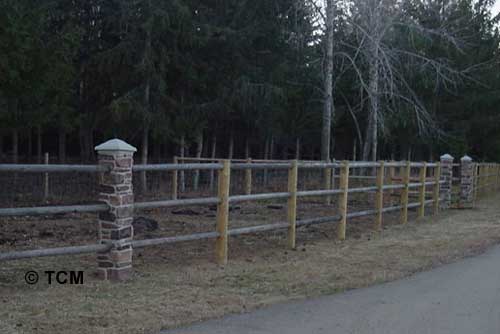 Faux Rock Columns shown with Wood Fence